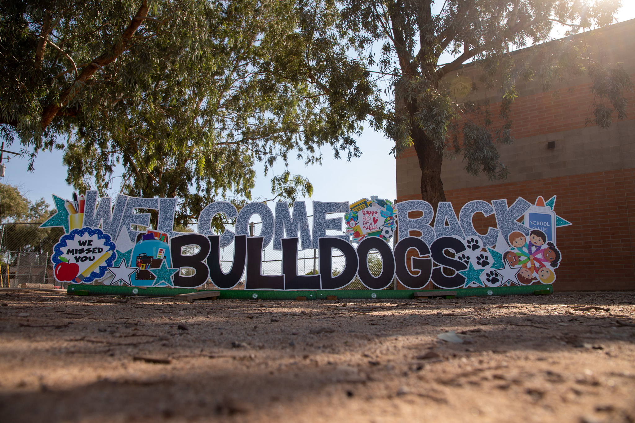 Letters reading Welcome Back Bulldogs on the school lawn