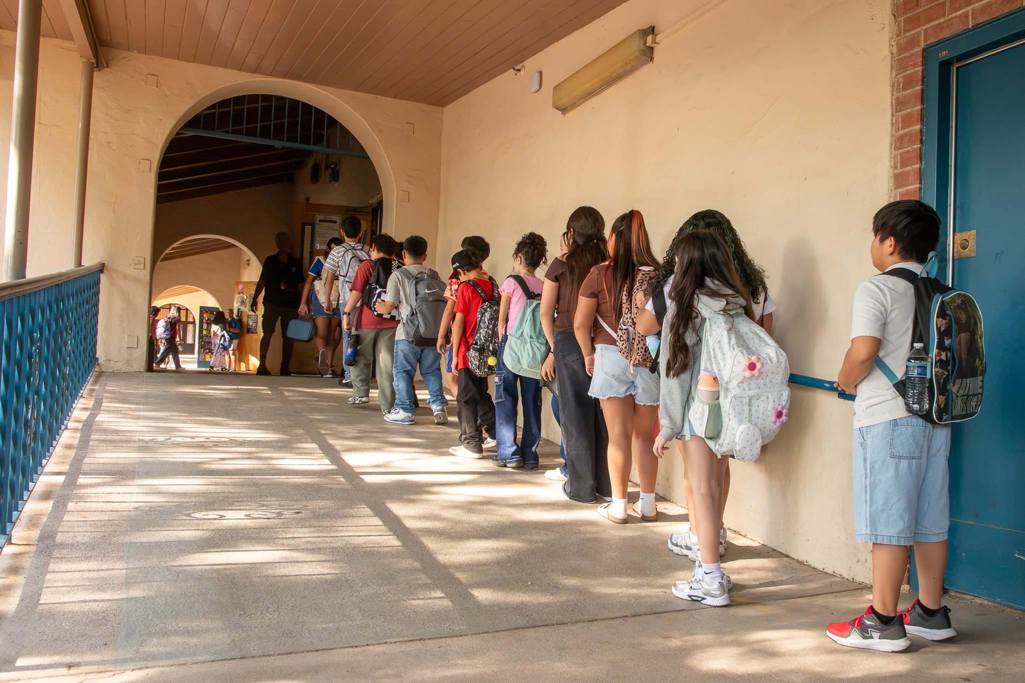 Students line up in the outdoor corridor