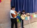 two students playing guitars together