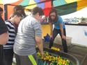 people playing a carnival game with rubber duckies