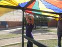 a person waving a rainbow tarp